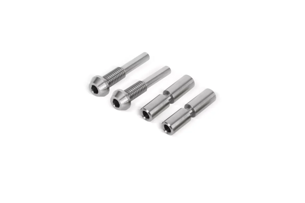 Four metal screws on white background
