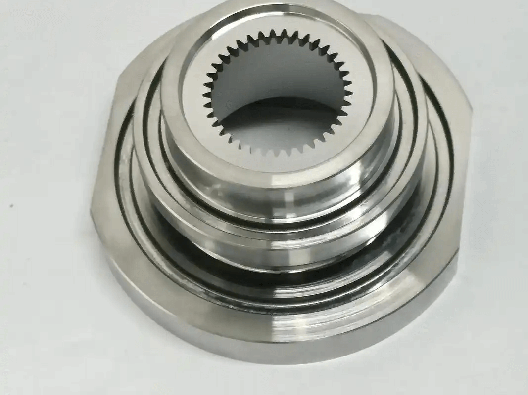 Metallic gear or toothed component on white background.