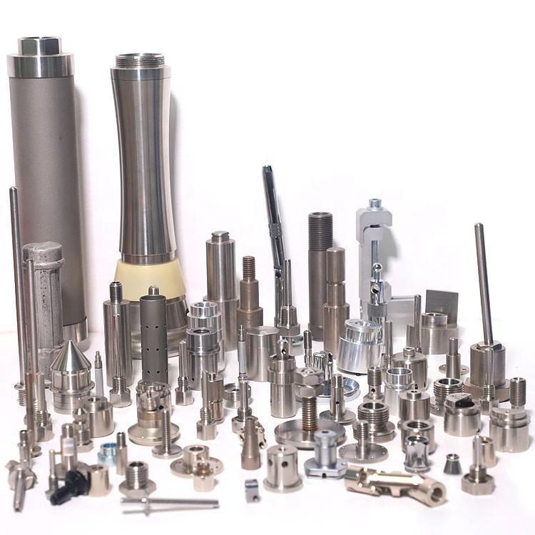 Assorted precision metal components on white background.