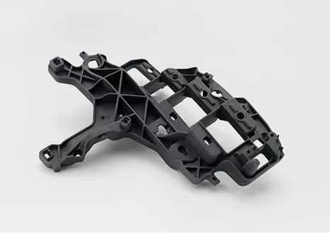 Black plastic automotive bracket on white background.