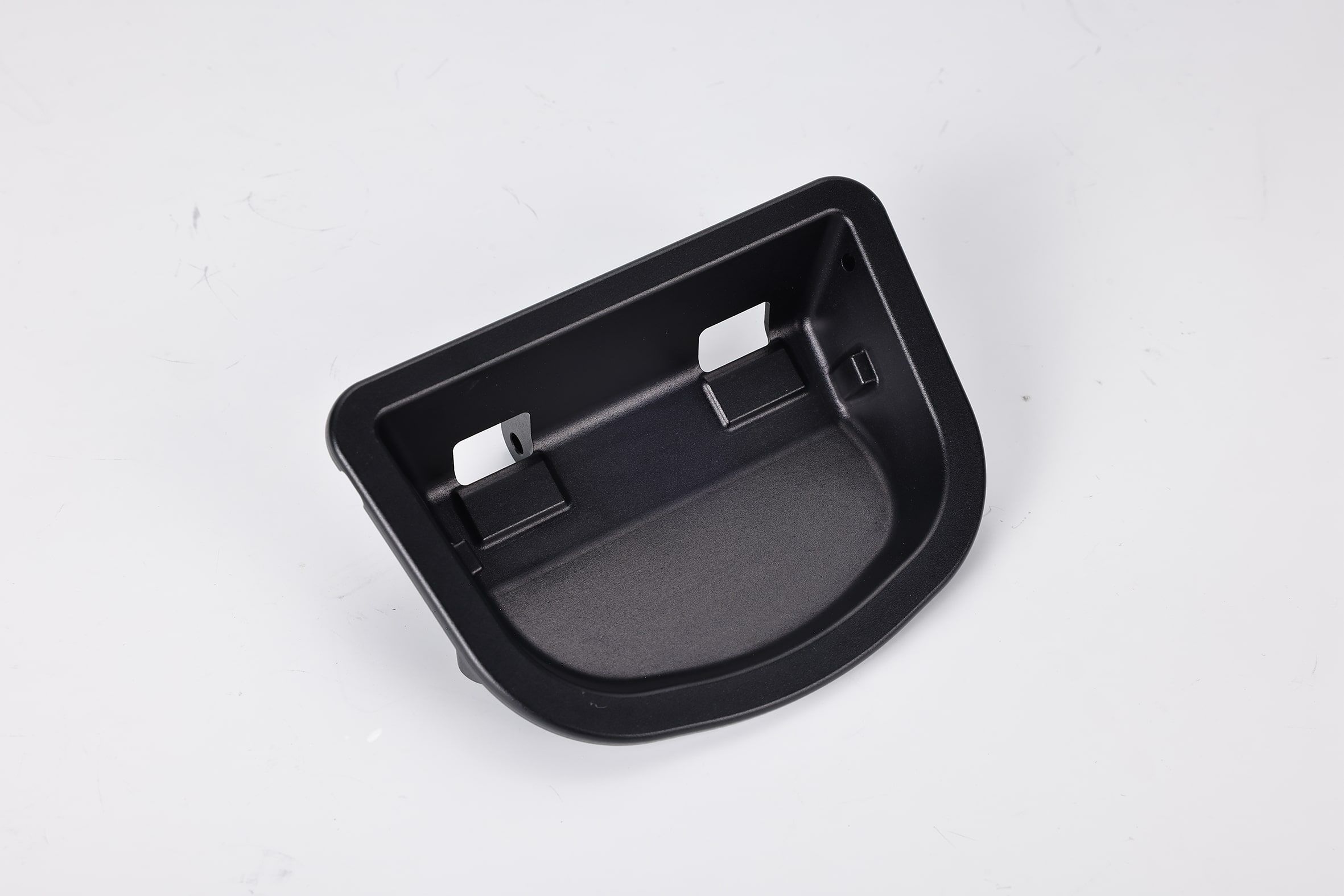 Black plastic automotive tray on white background