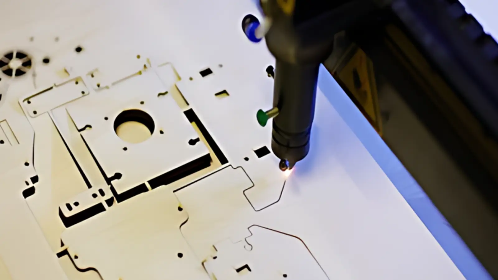 Laser cutter working on metal sheet design.