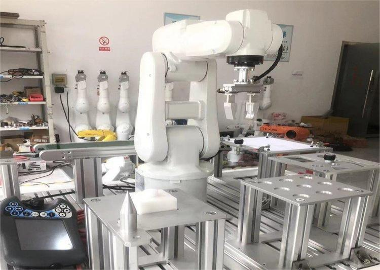 Industrial robotic arm in a manufacturing setup.