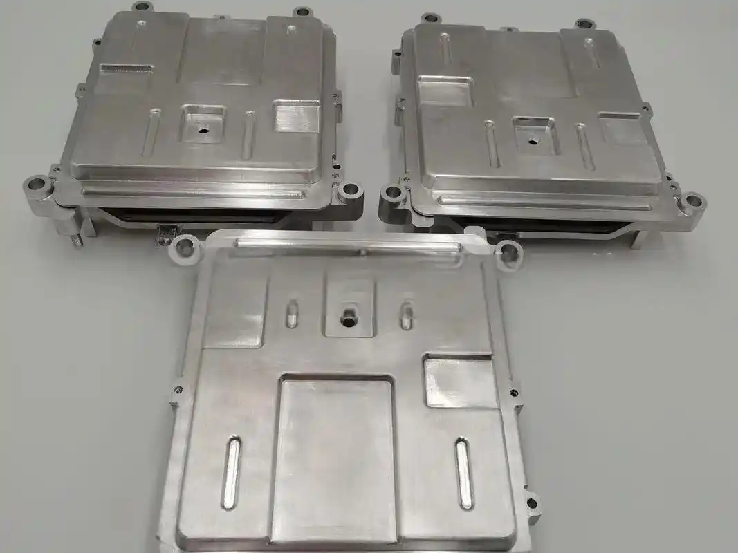 Three metal electronic enclosures on white background.