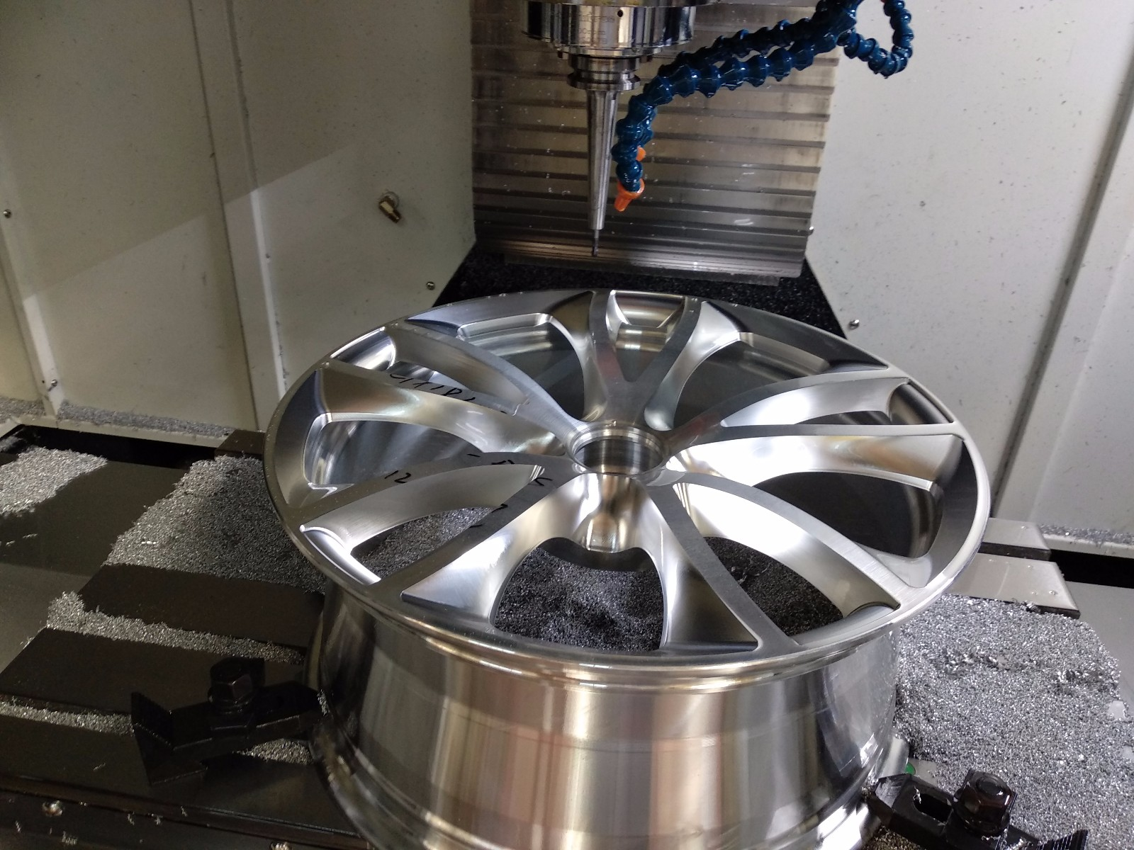 CNC machine creating alloy wheel rim