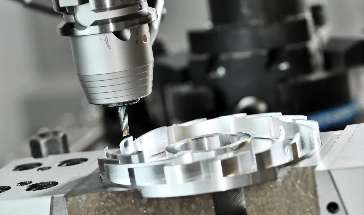 CNC machine drilling metal part in workshop.