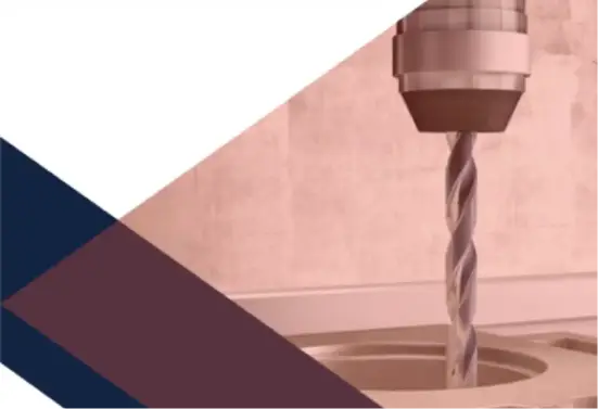Industrial drill cutting into metal surface