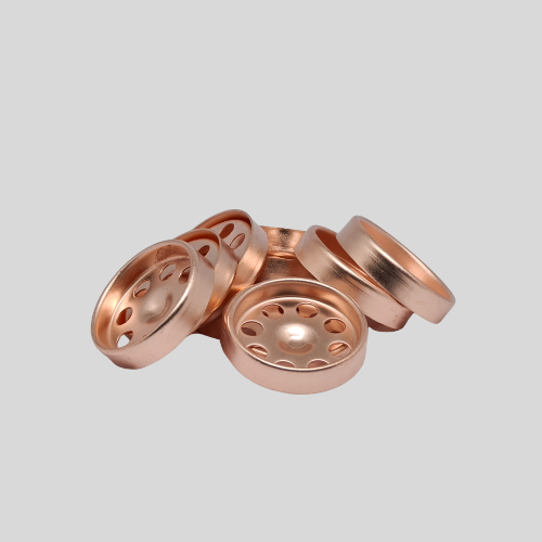 Copper round components with circular holes on gray background.