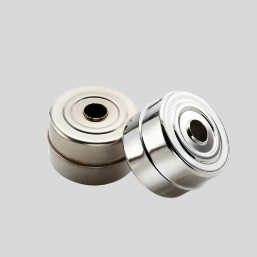 Close-up of two metal bearings on gray background.