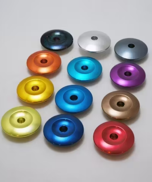 Colorful anodized aluminum rings arranged on white surface.