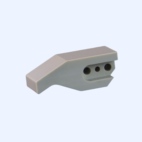 Gray plastic component with three circular holes.