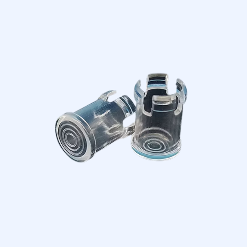 Two transparent plastic connectors on light background