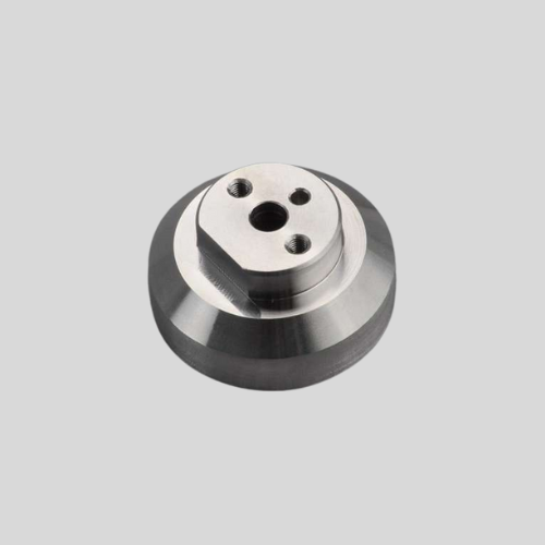Metal industrial component with holes, top view.