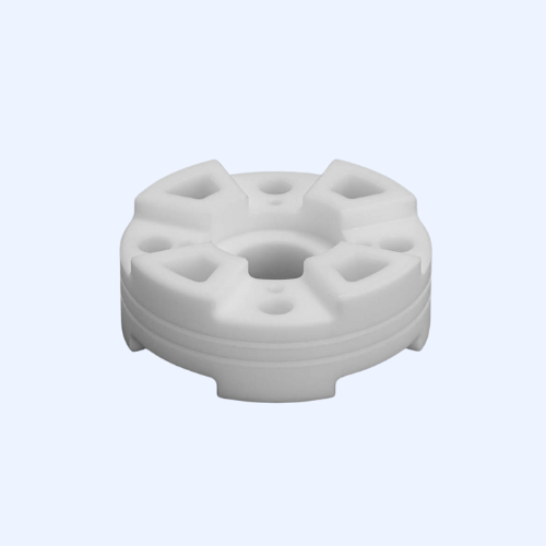 White plastic round component with holes, rotating part