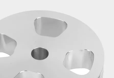 Close-up of a metal disc with holes.
