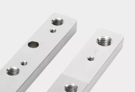 Machined metal bars with threaded holes